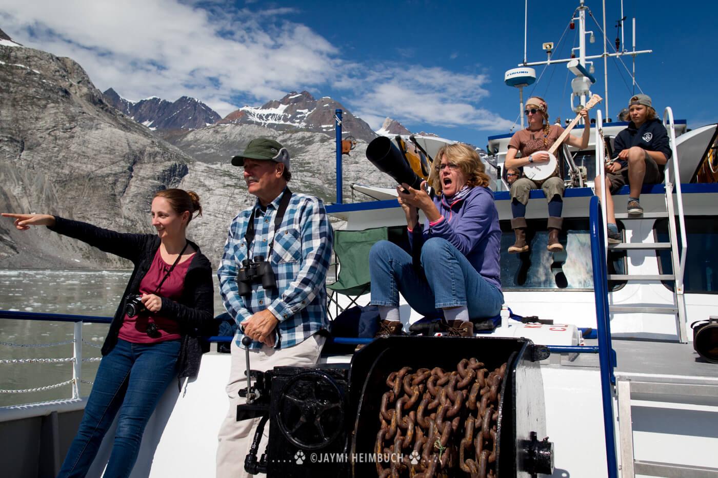 Passengers and crew observe wildlife from the ship's deck. © Jaymi Heimbuch