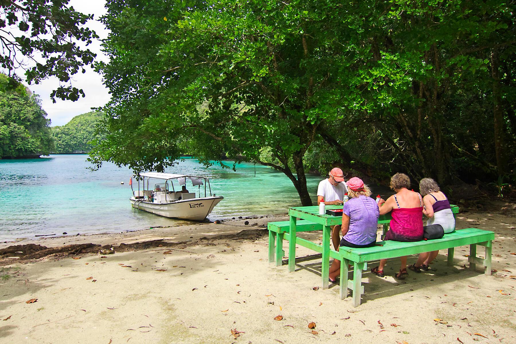 Travelers enjoy a picnic lunch in the Rock Islands. © Keoki Stender