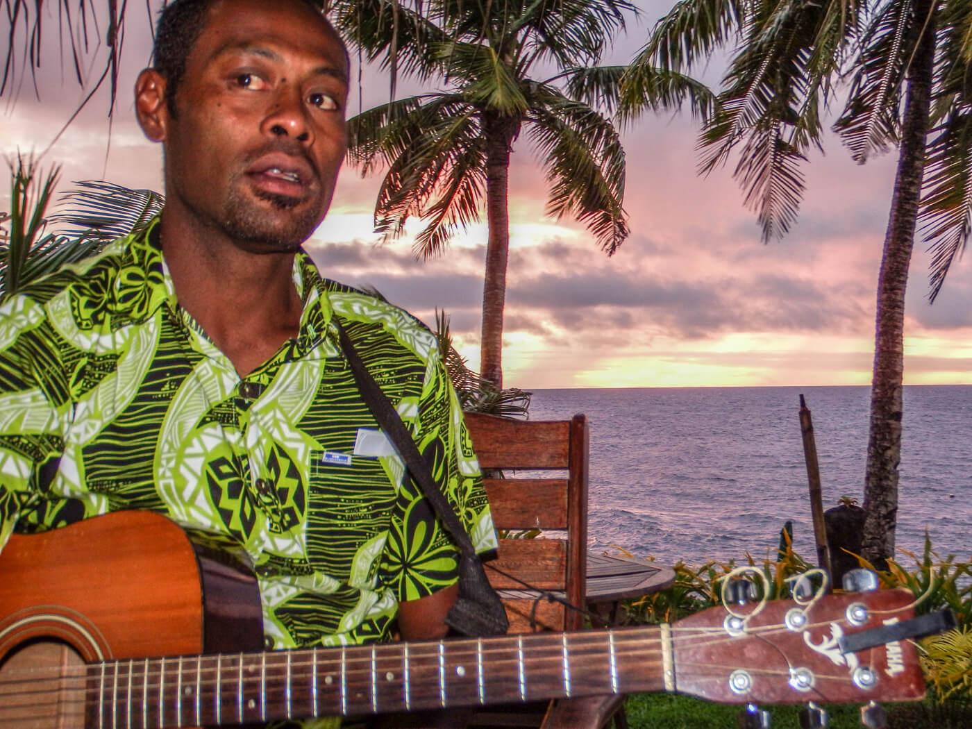 Soni plays guitar as the sun sets at Paradise Taveuni. © Roger Harris